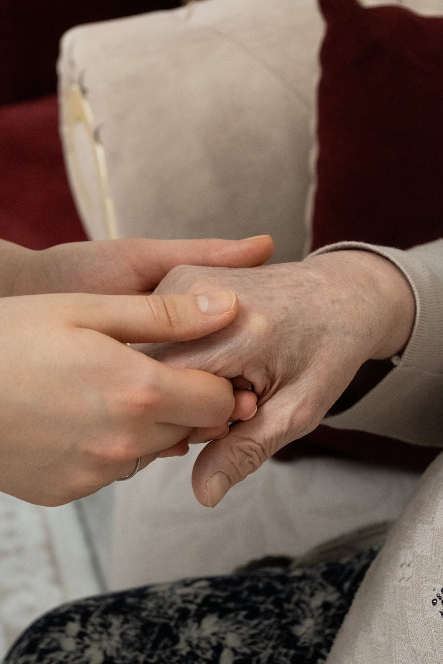 A carer holding an older person's hand